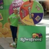a multicolored spin-the-wheel with branded information at an event